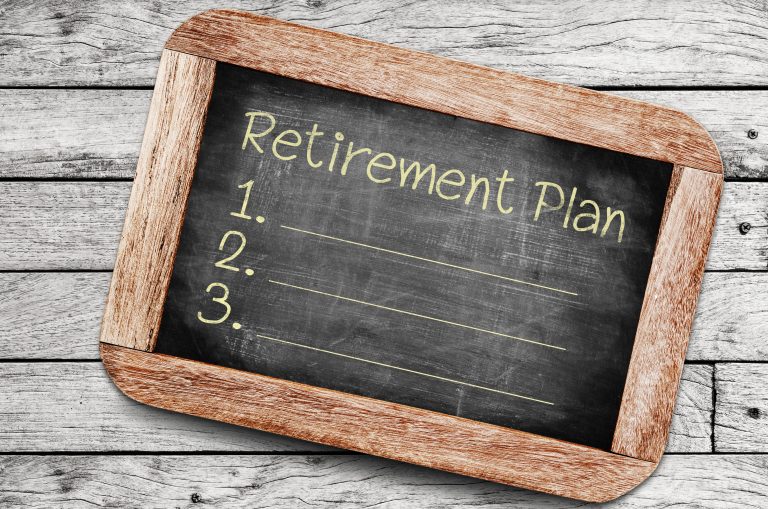 small chalk board with the words Retirement Plan and three blank lines